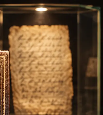 An old handwritten page inside a glass case
